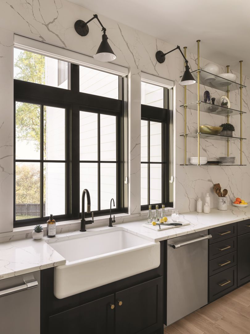 Black interior wood JELD-WEN Siteline® clad wood casement windows with colonial grilles set against marble backsplash in luxury kitchen remodel