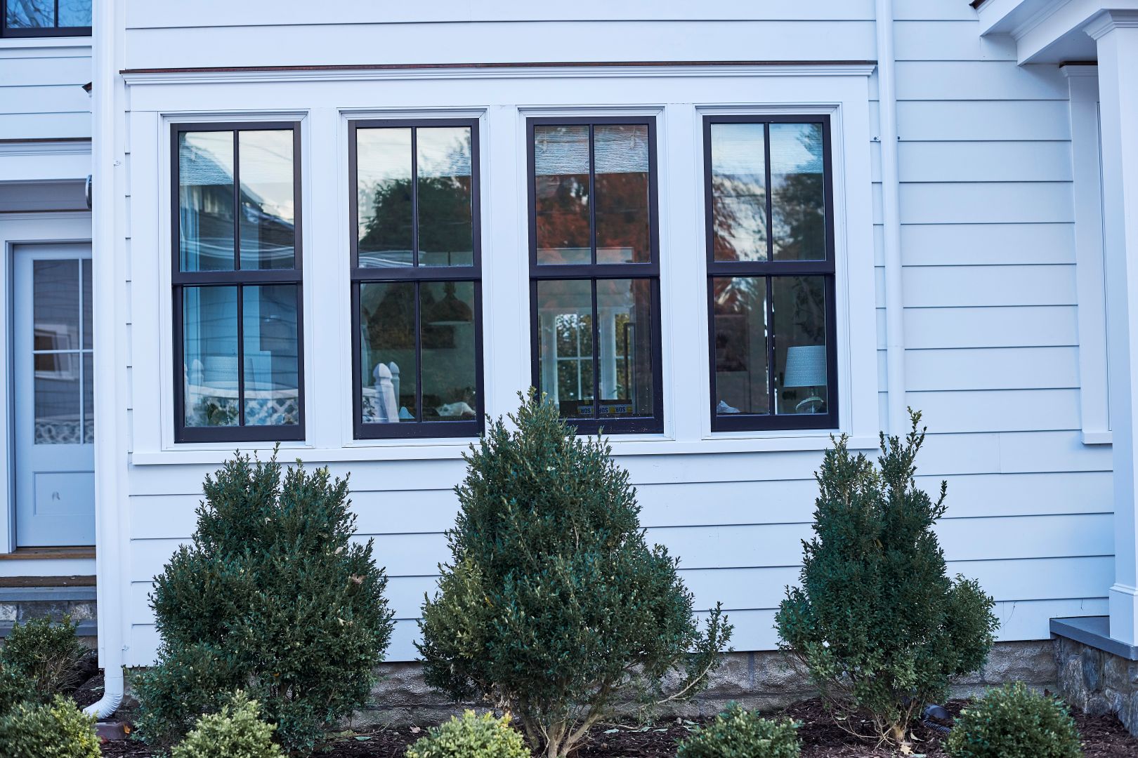 Bank of four JELD-WEN Siteline® clad wood double hung windows with simulated divided lites