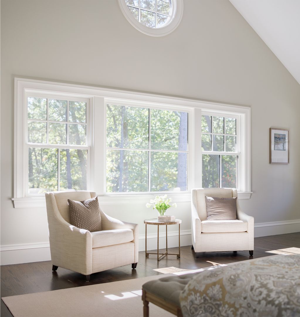 JELD-WEN Siteline® white wood double hung and picture windows with round accent window in vaulted ceiling room